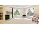 Bright bedroom featuring neutral walls, carpet flooring, recessed lights, and windows dressed with sheer, tie-back curtains at 3741 Cape York Trce, Alpharetta, GA 30022