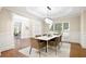 Refined dining area with modern decor, featuring hardwood floors, natural light, and comfortable seating at 3741 Cape York Trce, Alpharetta, GA 30022