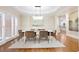 Elegant dining room with hardwood floors, sophisticated lighting, and views of the outdoor landscape at 3741 Cape York Trce, Alpharetta, GA 30022