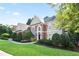 Lovely traditional-style home featuring a lush green lawn and mature trees for privacy and shade at 3741 Cape York Trce, Alpharetta, GA 30022