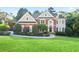 Beautiful two-story brick home with manicured lawn and landscaping, offering classic curb appeal at 3741 Cape York Trce, Alpharetta, GA 30022
