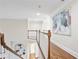 Bright hallway featuring hardwood floors, decorative molding, and a view of the lower level with built-in bookshelves at 3741 Cape York Trce, Alpharetta, GA 30022