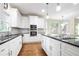Modern kitchen with stainless steel appliances, white cabinets, and a subway tile backsplash at 3741 Cape York Trce, Alpharetta, GA 30022