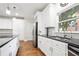Well-lit kitchen featuring granite countertops, white cabinetry, and stainless steel appliances at 3741 Cape York Trce, Alpharetta, GA 30022