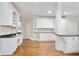 Spacious white kitchen featuring granite countertops, custom cabinets, and hardwood floors at 3741 Cape York Trce, Alpharetta, GA 30022