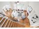 Open-concept living room with hardwood floors, neutral decor, a fireplace, and a staircase view from above at 3741 Cape York Trce, Alpharetta, GA 30022