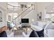 Bright living room with a staircase, hardwood floors, a large sofa, and elegant decor at 3741 Cape York Trce, Alpharetta, GA 30022