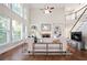 Sun-drenched living room with soaring ceilings, built-in shelving, and stylish furnishings, perfect for relaxation at 3741 Cape York Trce, Alpharetta, GA 30022