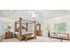 Spacious main bedroom featuring a canopy bed, sitting area, large windows and vaulted ceilings at 3741 Cape York Trce, Alpharetta, GA 30022