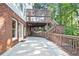 Spacious outdoor patio with brick and siding home exterior, featuring stairs to the backyard at 3741 Cape York Trce, Alpharetta, GA 30022
