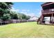 Expansive backyard featuring a well-maintained lawn and two-story deck with staircase at 610 Brickstone Ct, Covington, GA 30016