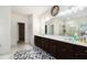 Large bathroom featuring a long vanity with double sinks and a large mirror at 610 Brickstone Ct, Covington, GA 30016