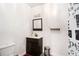 Bathroom featuring a modern vanity, toilet, decorative mirror, and shower curtain at 610 Brickstone Ct, Covington, GA 30016