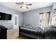 Bedroom with a ceiling fan, mounted TV, decorative curtains, and queen-sized bed at 610 Brickstone Ct, Covington, GA 30016