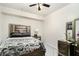 Cozy bedroom with an accent headboard, soft patterned carpet and ceiling fan at 610 Brickstone Ct, Covington, GA 30016