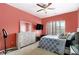 Bright bedroom with ceiling fan, mounted TV, a large window, and queen-size bed at 610 Brickstone Ct, Covington, GA 30016