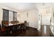 Spacious dining room with a wooden table, dark wood floors, and stylish decorative lighting at 610 Brickstone Ct, Covington, GA 30016