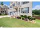 A close up of a charming two story home with beautiful landscaping around the front entrance at 610 Brickstone Ct, Covington, GA 30016
