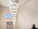 Modern foyer features an elegant, circular crystal chandelier that catches the light at 610 Brickstone Ct, Covington, GA 30016