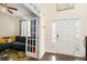 Inviting home entry with a decorative front door and a glimpse into the adjacent living room with dark wood floors at 610 Brickstone Ct, Covington, GA 30016