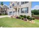 Close-up view of the home's beautiful landscaping, painted brick, and welcoming front porch at 610 Brickstone Ct, Covington, GA 30016