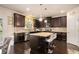 Kitchen with dark cabinets, stainless steel appliances, island with seating and granite countertops at 610 Brickstone Ct, Covington, GA 30016