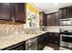 Updated kitchen with stainless steel appliances, tiled backsplash, and granite countertops at 610 Brickstone Ct, Covington, GA 30016
