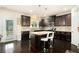 Modern kitchen featuring dark cabinetry, granite countertops, and an island with seating at 610 Brickstone Ct, Covington, GA 30016