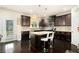 Well-equipped kitchen with dark cabinetry, granite countertops, stainless steel appliances, and a center island at 610 Brickstone Ct, Covington, GA 30016