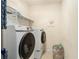 Laundry room featuring modern washer and dryer appliances, plus shelving for storage at 610 Brickstone Ct, Covington, GA 30016