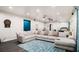 Spacious living area with a large sectional sofa, dark wood floors and plenty of lighting at 610 Brickstone Ct, Covington, GA 30016