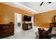 Open main bedroom with TV, connecting to a bathroom; features neutral carpeting and warm colors at 610 Brickstone Ct, Covington, GA 30016