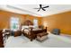 Spacious main bedroom with tray ceiling, ceiling fan, large bed, and ample natural light at 610 Brickstone Ct, Covington, GA 30016