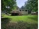 Large backyard with a two story house and a spacious wooden deck at 636 Raven Springs Trl, Stone Mountain, GA 30087
