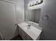 Bathroom with white vanity and modern light fixture at 636 Raven Springs Trl, Stone Mountain, GA 30087