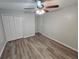 Bedroom with vinyl floors, ceiling fan, and closet at 636 Raven Springs Trl, Stone Mountain, GA 30087