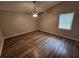 Spacious bedroom features wood floors and neutral paint, creating a bright and inviting space at 636 Raven Springs Trl, Stone Mountain, GA 30087