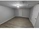 A bedroom featuring modern flooring, neutral walls, overhead lighting, and a door at 636 Raven Springs Trl, Stone Mountain, GA 30087