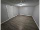 A bedroom featuring modern flooring, neutral walls, overhead lighting, and a door at 636 Raven Springs Trl, Stone Mountain, GA 30087