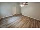 A well-lit bedroom featuring neutral walls, stylish wood flooring, and a ceiling fan at 636 Raven Springs Trl, Stone Mountain, GA 30087
