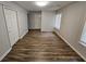 A bright bedroom with neutral colors, two windows, and new flooring at 636 Raven Springs Trl, Stone Mountain, GA 30087