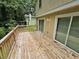 Spacious wooden deck features glass sliding doors and wooded views at 636 Raven Springs Trl, Stone Mountain, GA 30087