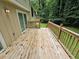 Inviting wooden deck with railings offers a peaceful outdoor space with wooded views at 636 Raven Springs Trl, Stone Mountain, GA 30087