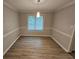 Neutral dining room with modern floors, chair rail, and updated light fixture at 636 Raven Springs Trl, Stone Mountain, GA 30087