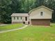 Inviting two-story home with a well-manicured lawn and pathway leading to the front entrance at 636 Raven Springs Trl, Stone Mountain, GA 30087
