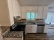 Traditional kitchen featuring granite counters, stainless appliances, and wooden floors at 636 Raven Springs Trl, Stone Mountain, GA 30087