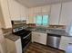 A modern kitchen with stainless appliances, granite countertops, and custom cabinets at 636 Raven Springs Trl, Stone Mountain, GA 30087