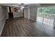 An open-concept living room with new flooring, patio access and adjacent kitchen at 636 Raven Springs Trl, Stone Mountain, GA 30087