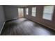 Spacious living room with modern floors, light gray walls, and plenty of natural light at 636 Raven Springs Trl, Stone Mountain, GA 30087