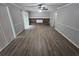 A spacious living room featuring modern flooring and a stone fireplace at 636 Raven Springs Trl, Stone Mountain, GA 30087